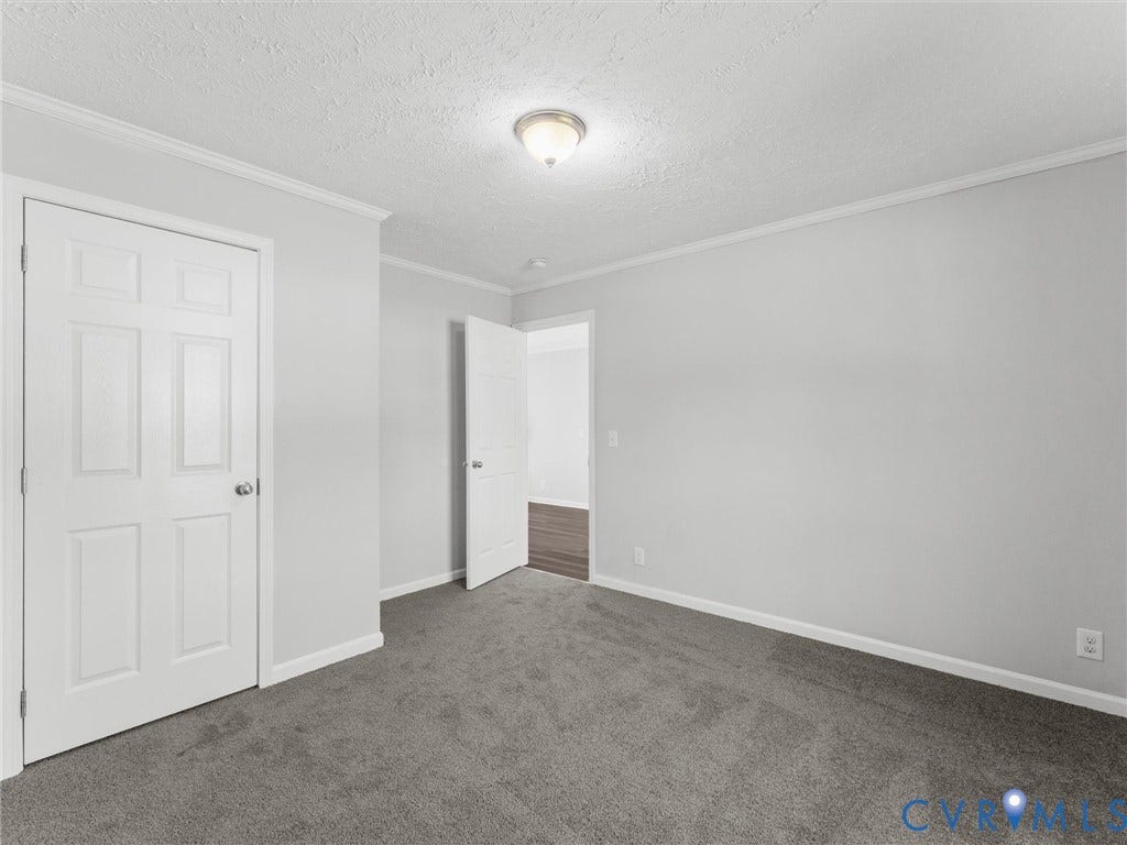 1625 Cedar Lane, Powhatan, VA 23139 Interior room featuring neutral-toned carpeting, light gray walls, white six-panel doors, and a flush-mount ceiling light fixture