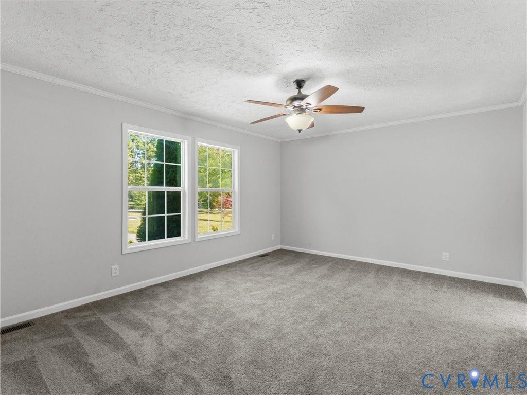 1625 Cedar Lane, Powhatan, VA 23139 Neutral interior featuring plush wall-to-wall carpeting, multiple windows with grid muntins, and a ceiling fan with integrated light fixture