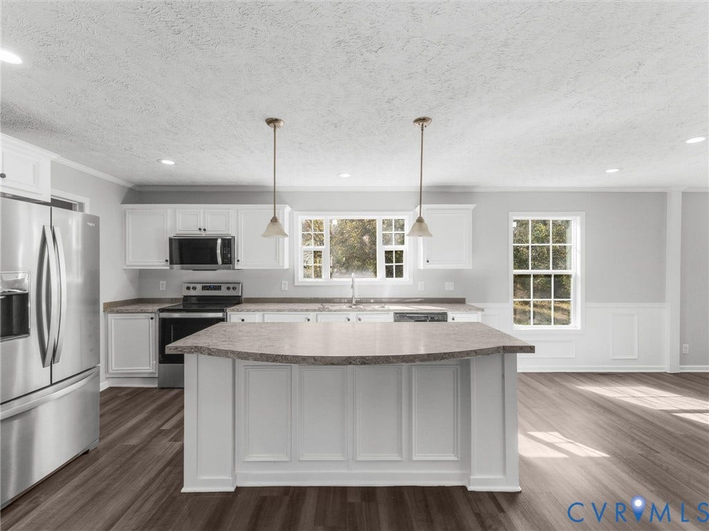 1625 Cedar Lane, Powhatan, VA 23139 Kitchen featuring white cabinetry, center island with a stone-finish countertop, stainless steel appliances, pendant lighting, and wood-finish flooring