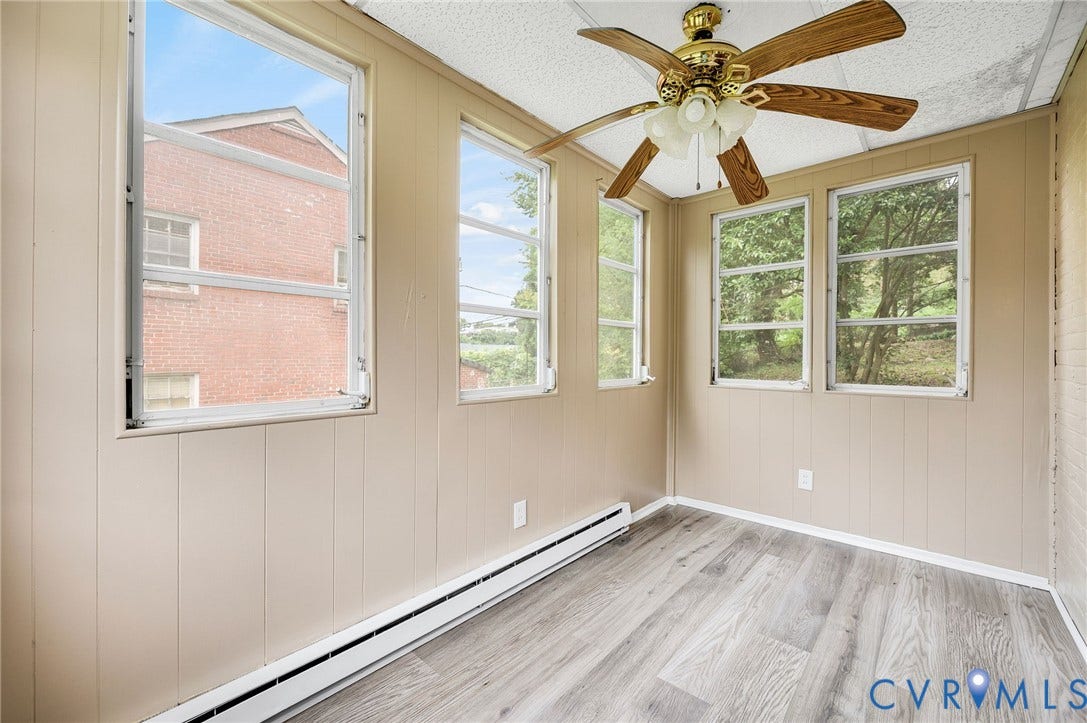 602 N 39th Street, Chimborazo, Richmond, VA 23223 Interior space featuring wood-finish flooring, multiple windows, and a ceiling fan with light fixture