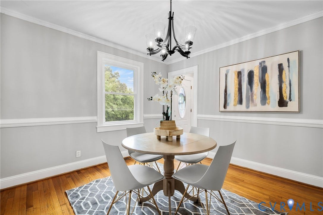 602 N 39th Street, Chimborazo, Richmond, VA 23223 Dining area featuring hardwood flooring, crown molding, chair rail detailing, and a multi-arm iron chandelier