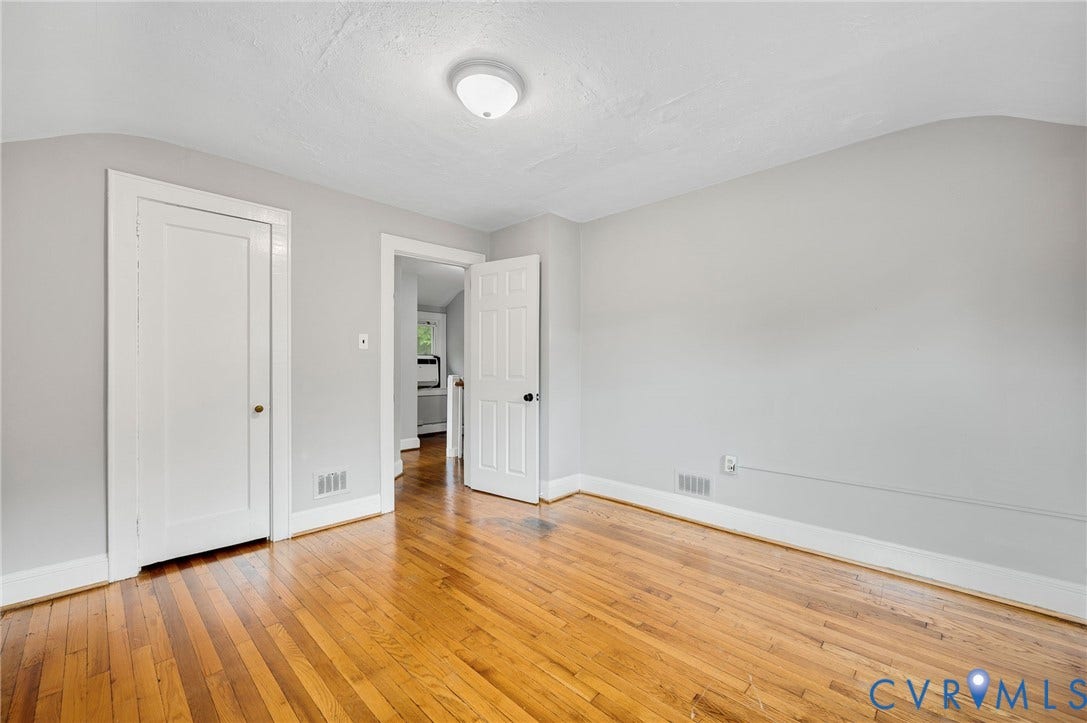 602 N 39th Street, Chimborazo, Richmond, VA 23223 Room featuring wood-finish flooring, neutral wall paint, a ceiling-mounted flush light fixture, and two interior doors with paneled detailing