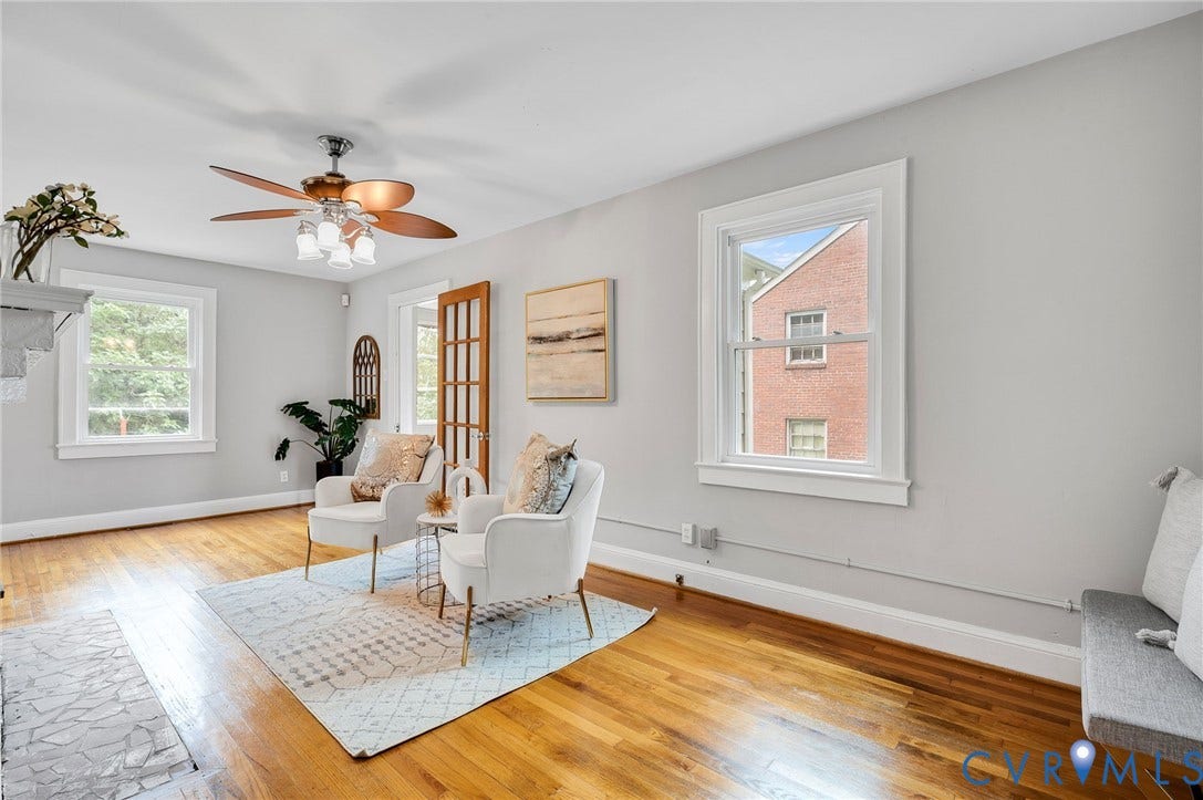 602 N 39th Street, Chimborazo, Richmond, VA 23223 Living space featuring wood-finish flooring, double-hung windows with white trim, a multi-light wood door, and a ceiling fan with integrated lighting