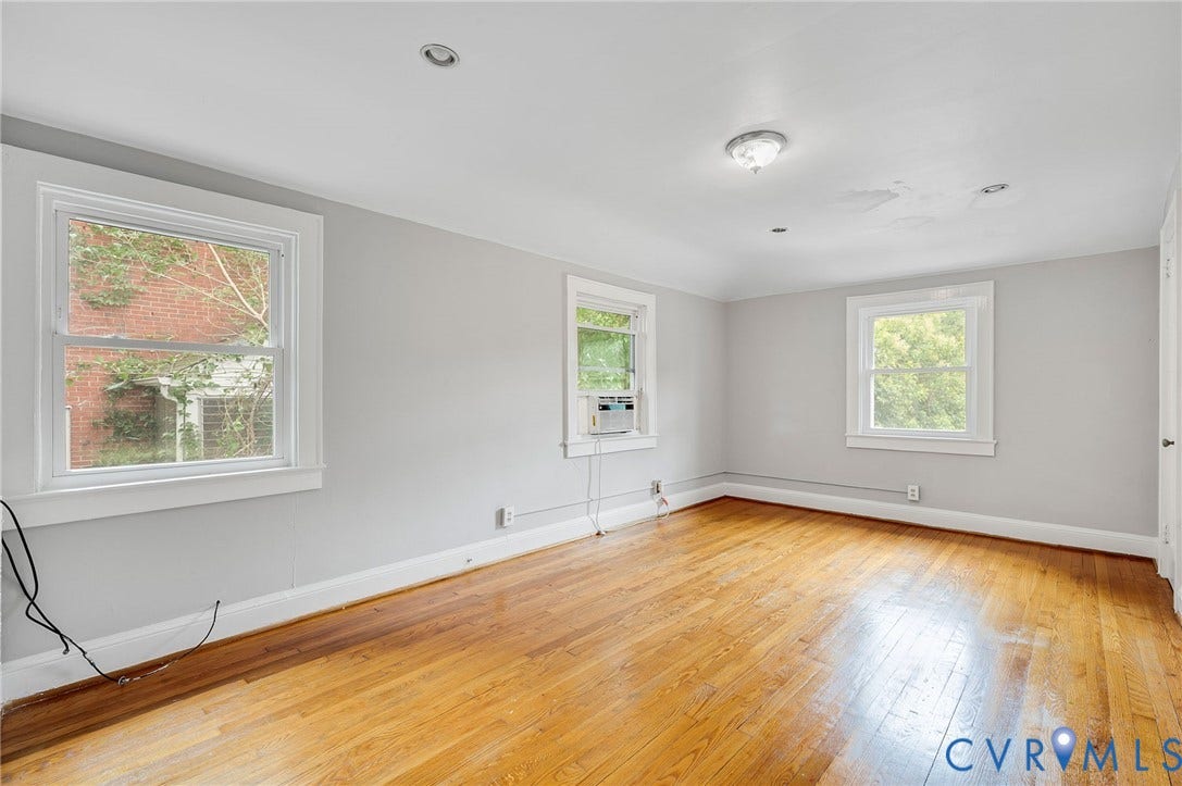 602 N 39th Street, Chimborazo, Richmond, VA 23223 Interior room featuring wood-finish flooring, recessed lighting, and three double-hung windows with white casing