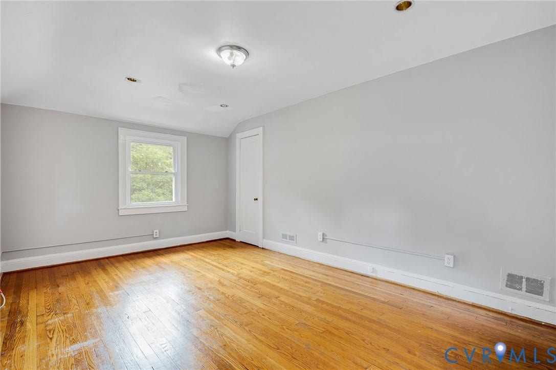 602 N 39th Street, Chimborazo, Richmond, VA 23223 Room featuring wood-finish flooring, neutral wall paint, a single window, and a flush-mount ceiling fixture with recessed lighting