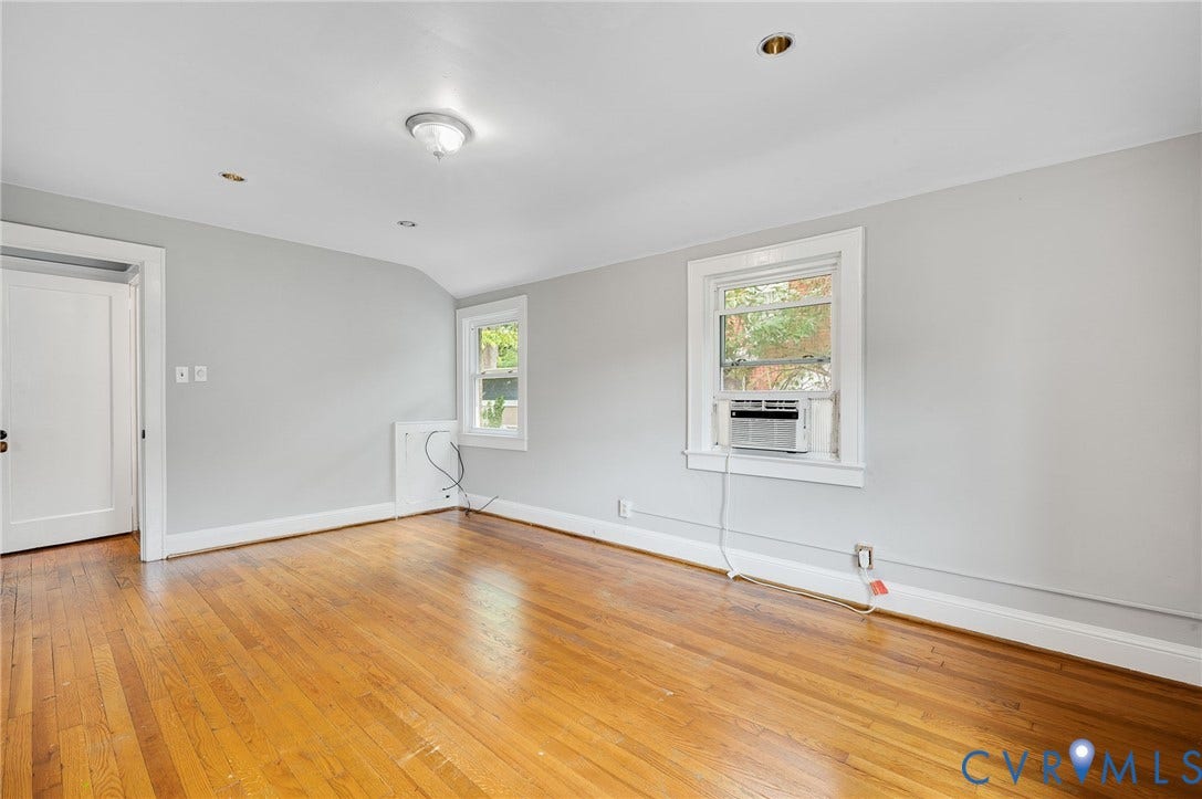 602 N 39th Street, Chimborazo, Richmond, VA 23223 Interior room featuring wood-finish flooring, neutral wall paint, two double-hung windows, and ceiling-mounted light fixtures
