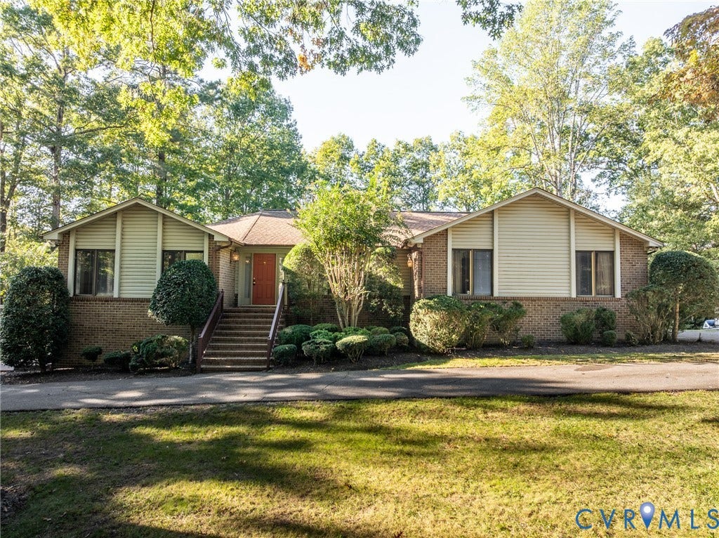 10862 Walton Lake Road, Dick Woods Subdivision, Disputanta, VA 23842 Ranch-style exterior featuring a brick and siding facade, asphalt shingle roof, prominent front staircase, and a paved driveway