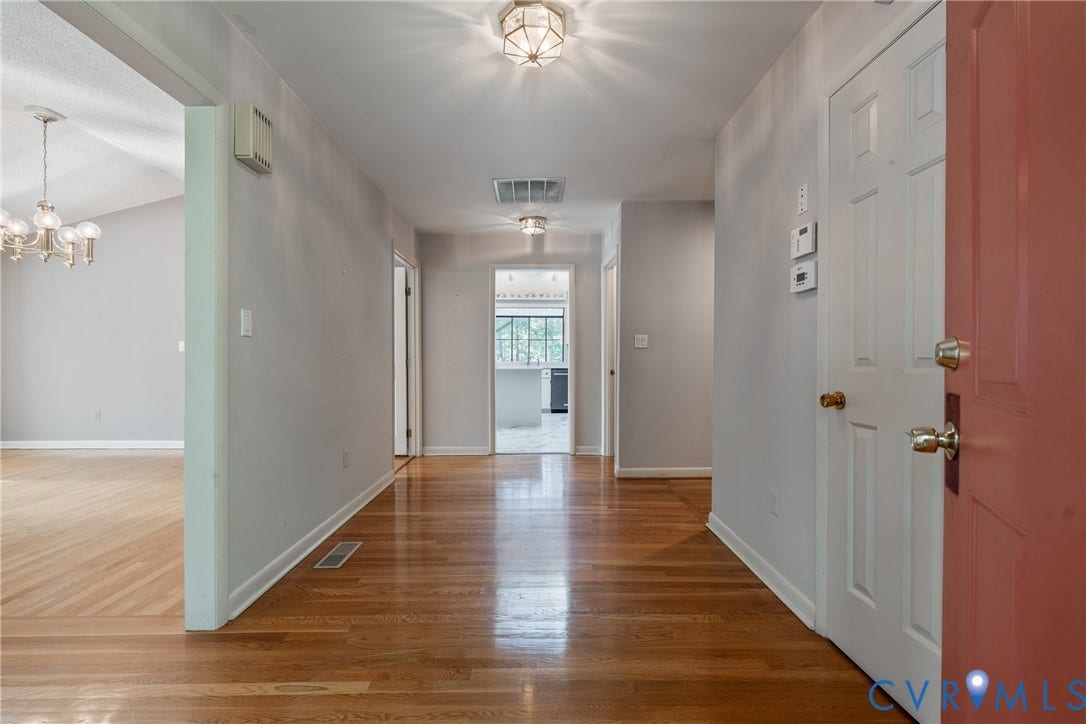 10862 Walton Lake Road, Dick Woods Subdivision, Disputanta, VA 23842 Foyer featuring wood-finish flooring, neutral wall paint, and multi-light flush-mount fixtures
