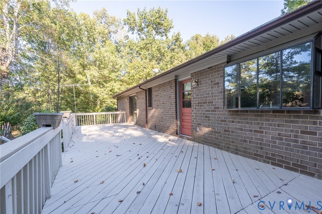 10862 Walton Lake Road, Dick Woods Subdivision, Disputanta, VA 23842 Exterior deck with painted wood railing, brick masonry siding, bay window, and exterior door with glass insert