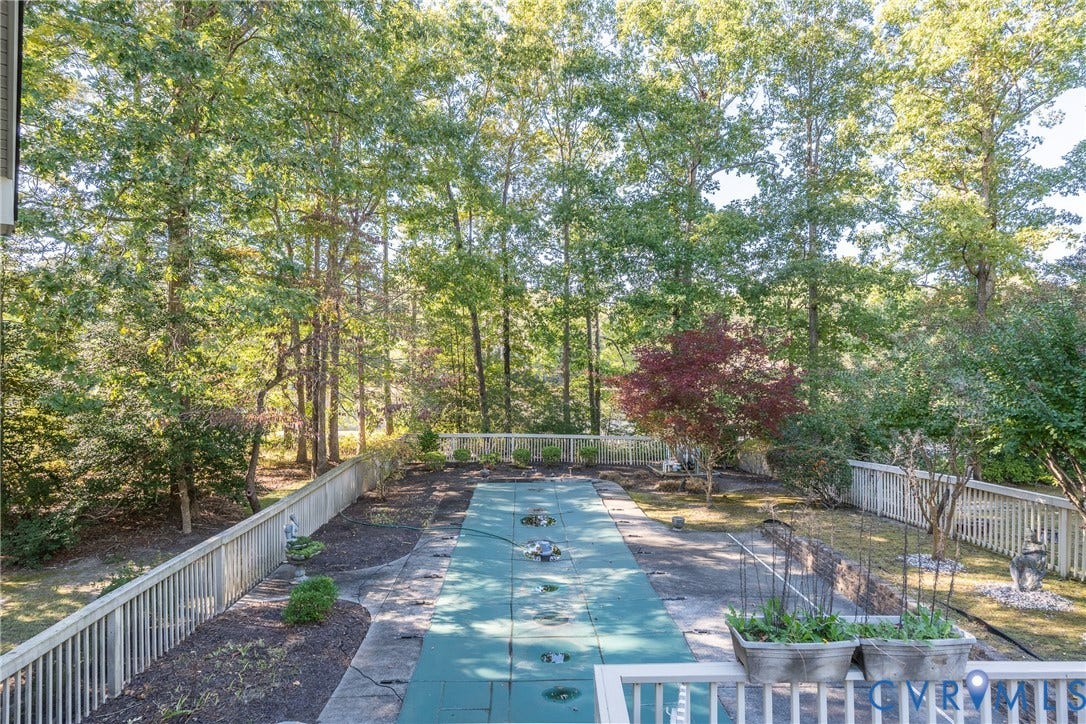 10862 Walton Lake Road, Dick Woods Subdivision, Disputanta, VA 23842 Outdoor space featuring a fenced backyard, an in-ground pool with a safety cover, and perimeter landscaping with mature trees