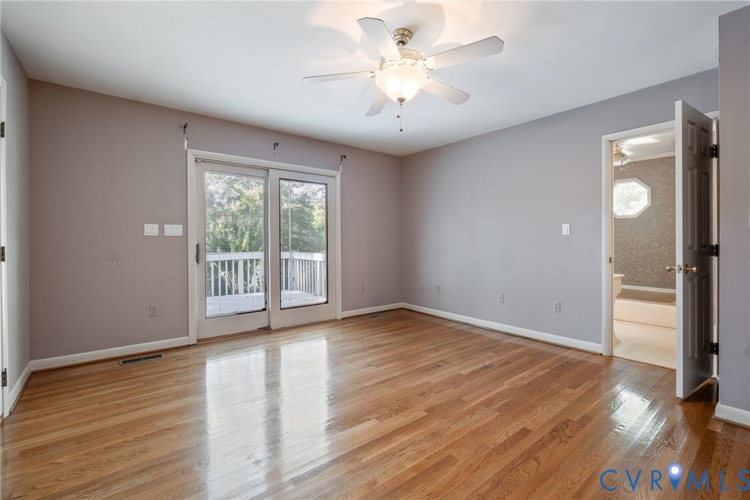 10862 Walton Lake Road, Dick Woods Subdivision, Disputanta, VA 23842 Interior room featuring wood-finish flooring, a ceiling fan with integrated lighting, and glass sliding doors leading to an outdoor deck