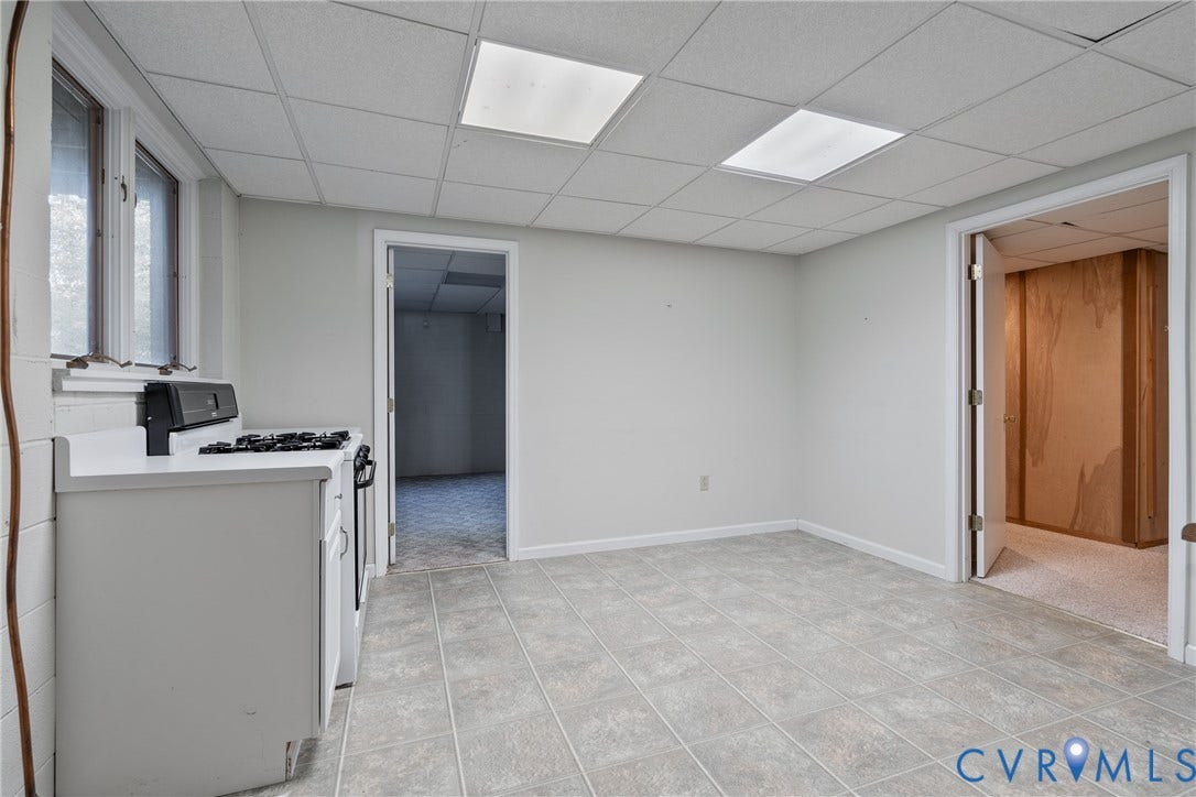 10862 Walton Lake Road, Dick Woods Subdivision, Disputanta, VA 23842 Interior space featuring a suspended drop ceiling with recessed panel lighting, tiled flooring, painted concrete block walls, and a built-in range