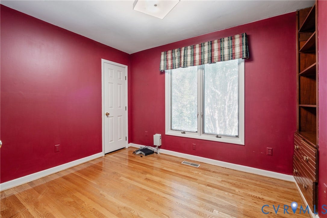 10862 Walton Lake Road, Dick Woods Subdivision, Disputanta, VA 23842 Room featuring wood-finish flooring, built-in wooden shelving, and a double-pane window