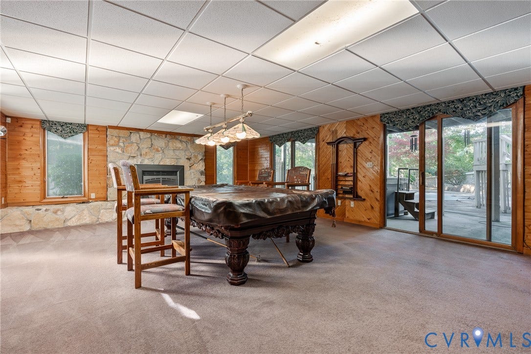 10862 Walton Lake Road, Dick Woods Subdivision, Disputanta, VA 23842 Stone masonry fireplace, wood-paneled walls, sliding glass door, recessed lighting, and wall-mounted shelving unit
