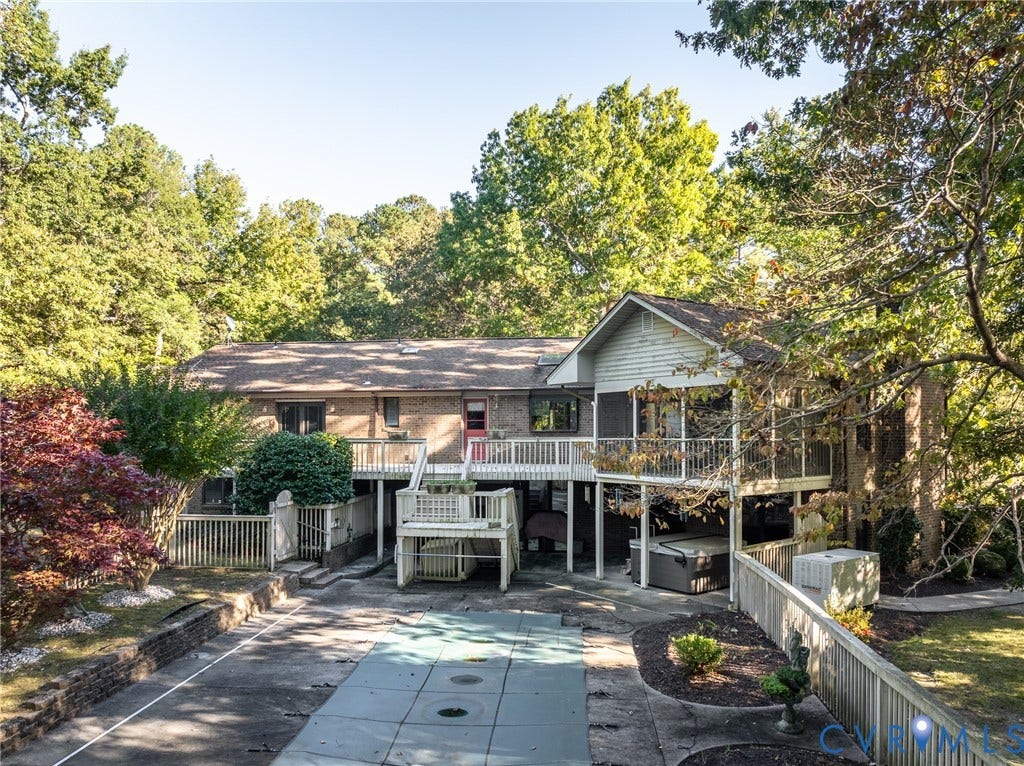 10862 Walton Lake Road, Dick Woods Subdivision, Disputanta, VA 23842 Brick and siding exterior featuring a multi-level deck, screened-in porch, in-ground pool, and privacy fencing