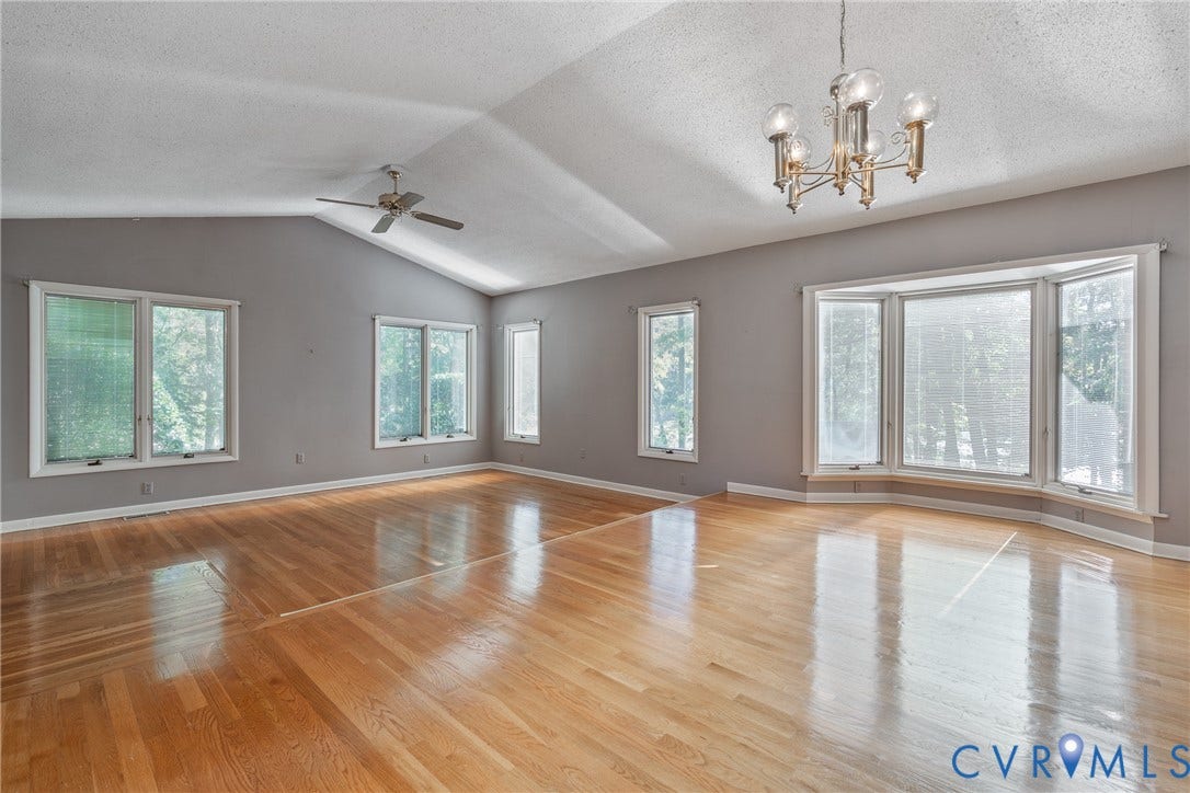 10862 Walton Lake Road, Dick Woods Subdivision, Disputanta, VA 23842 Vaulted ceilings, wood-finish flooring, multi-pane windows, a bay window, and a multi-arm chandelier