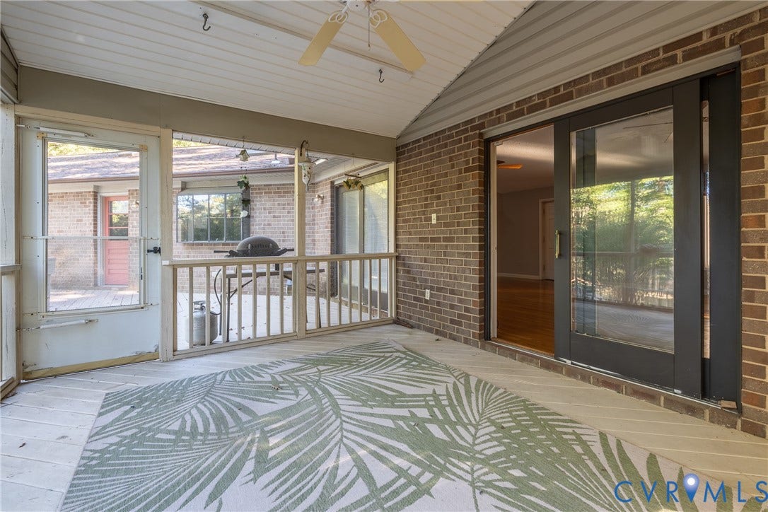 10862 Walton Lake Road, Dick Woods Subdivision, Disputanta, VA 23842 Screened-in porch featuring brick exterior walls, wood-finish flooring, a ceiling fan, and sliding glass entry doors