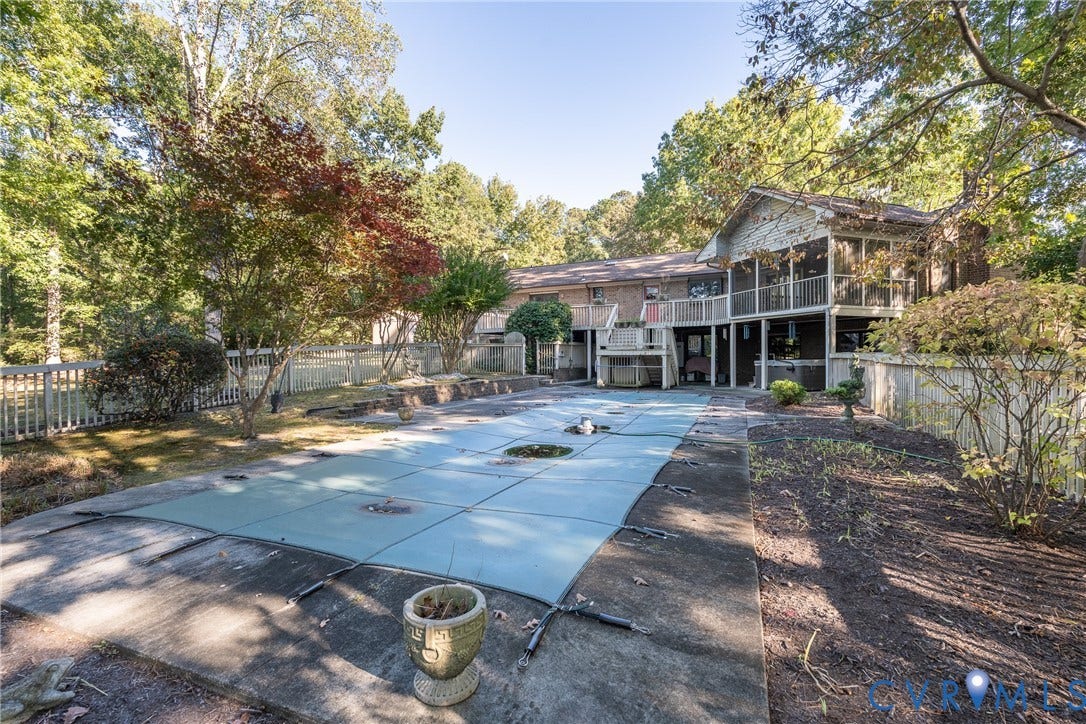 10862 Walton Lake Road, Dick Woods Subdivision, Disputanta, VA 23842 Rear exterior featuring a covered deck, screened porch, swimming pool with safety cover, concrete decking, and perimeter fencing