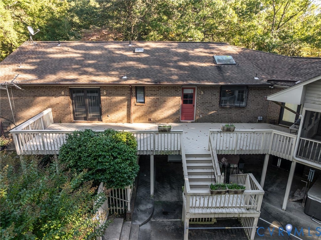 10862 Walton Lake Road, Dick Woods Subdivision, Disputanta, VA 23842 Multi-level wooden deck featuring stairs and railing, brick exterior, skylights, and glass-paned entry door