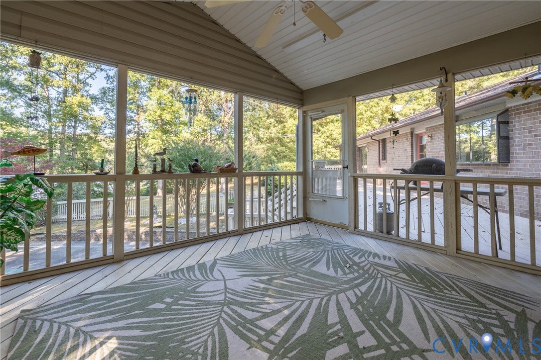 10862 Walton Lake Road, Dick Woods Subdivision, Disputanta, VA 23842 Screened-in porch featuring wood-plank flooring, a vaulted ceiling with a mounted fan, and wooden railings