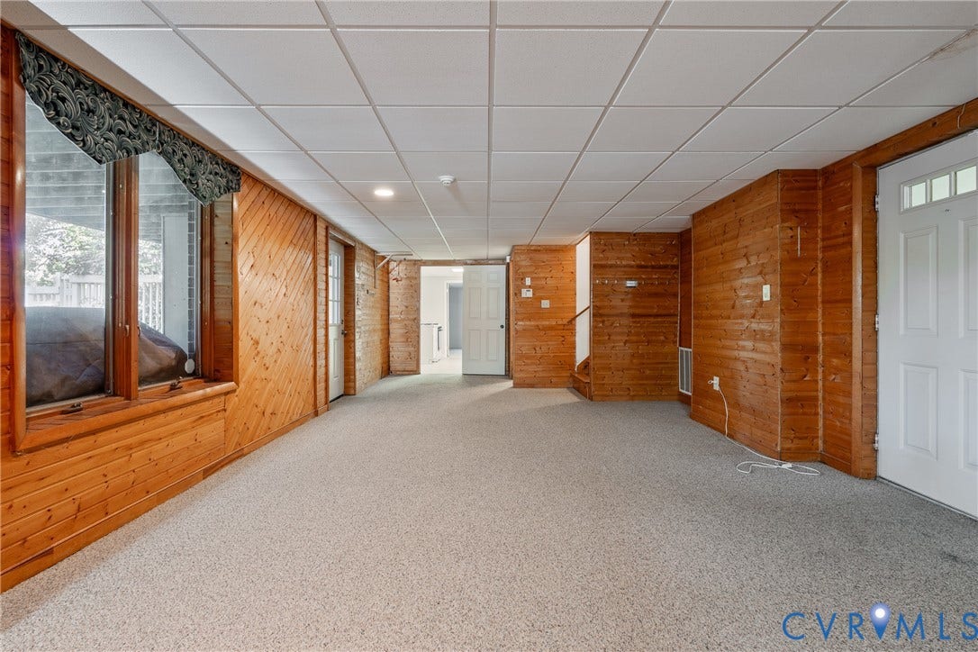 10862 Walton Lake Road, Dick Woods Subdivision, Disputanta, VA 23842 Wood-paneled walls, carpeted flooring, drop ceiling, and multiple white-paneled doors