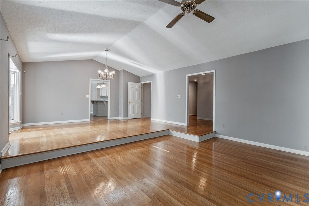 10862 Walton Lake Road, Dick Woods Subdivision, Disputanta, VA 23842 Vaulted ceilings featuring a multi-arm chandelier, wood-finish flooring, and a multi-level floor plan