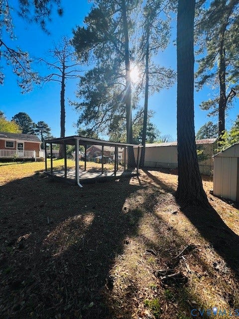 1525 Circle Drive, Petersburg, VA 23803 Expansive lot featuring mature trees, an open-sided pavilion, and a detached storage structure