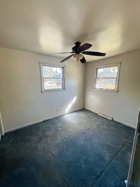 1525 Circle Drive, Petersburg, VA 23803 Room featuring neutral-toned walls, carpeting, two multi-pane windows, and a ceiling fan with integrated lighting