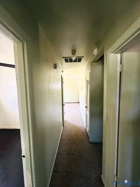 1525 Circle Drive, Petersburg, VA 23803 Interior corridor featuring neutral wall finishes, carpeting, and a built-in louvered closet door