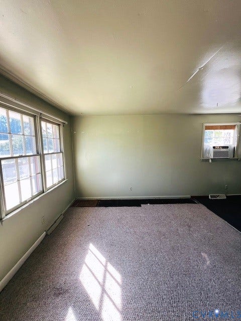 1525 Circle Drive, Petersburg, VA 23803 Room featuring multi-pane windows, wall-to-wall carpeting, and a wall-mounted air conditioning unit