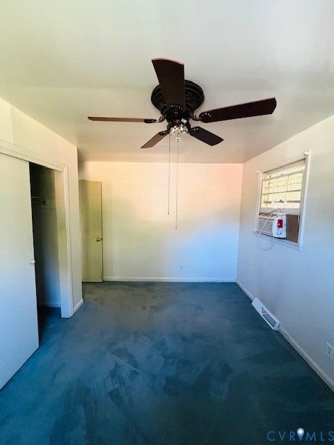 1525 Circle Drive, Petersburg, VA 23803 Interior space featuring carpeted flooring, a ceiling fan with integrated lighting, and a window with a mounted cooling unit