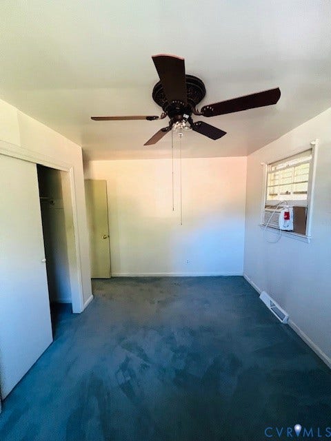1525 Circle Drive, Petersburg, VA 23803 Room featuring carpeting, a ceiling fan with integrated light fixture, a closet with sliding doors, and a window