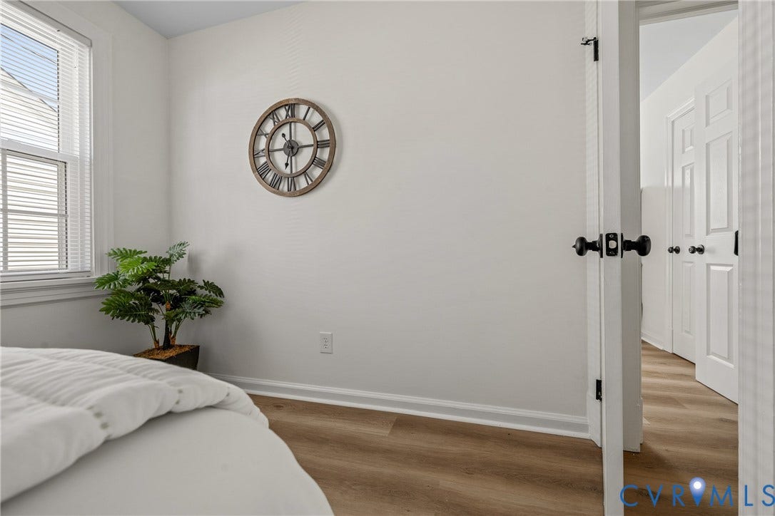 2106 Kenwood Avenue, Henrico, VA 22229 Interior space featuring wood-finish flooring, white walls, and a single-hung window with horizontal blinds