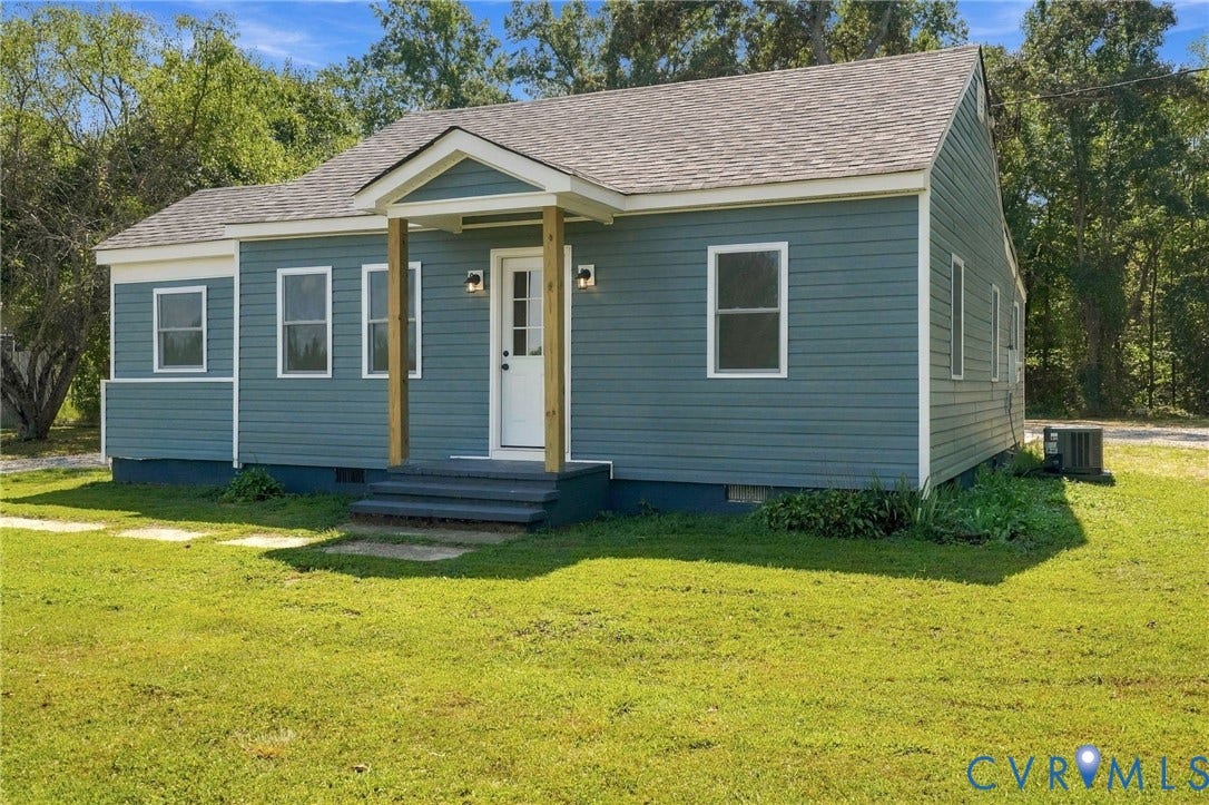 Exterior featuring blue horizontal siding, a gabled roofline, covered front entryway with wood-finish support posts, and double-hung windows