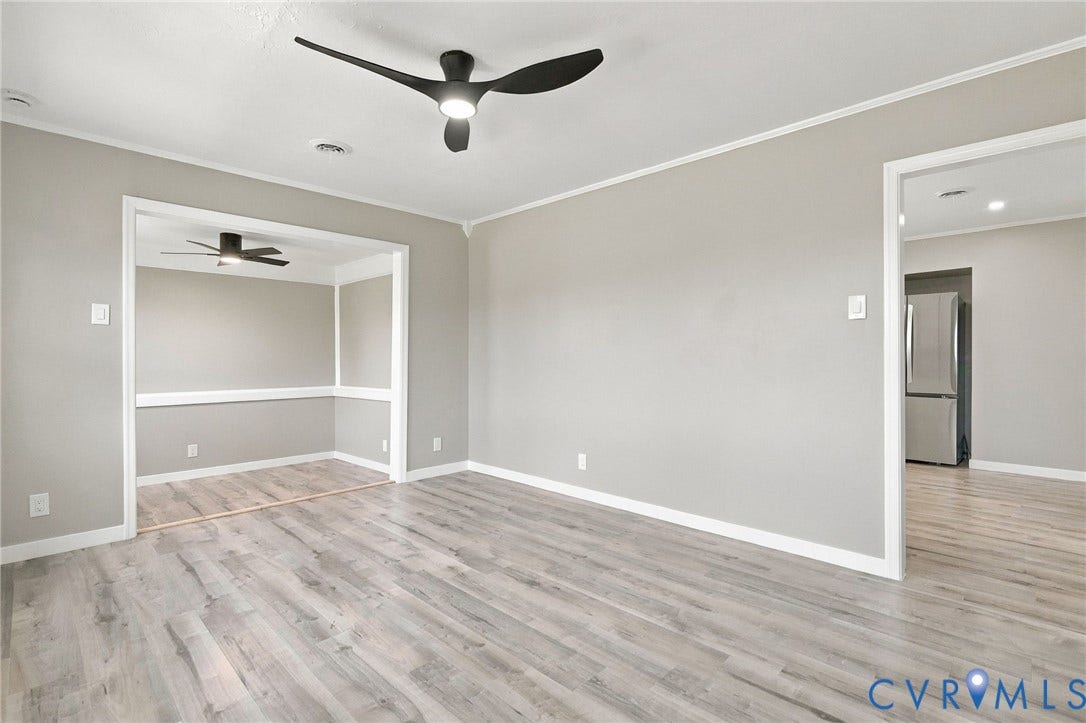 Wood-finish flooring, neutral wall tones, multi-blade ceiling fans, and chair rail molding