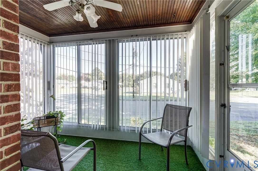 4007 Austin Avenue, Richmond, VA 23222 Enclosed porch featuring a wood-plank ceiling, exposed brick wall, floor-to-ceiling glass windows, vertical blinds, and an overhead ceiling fan with light fixture