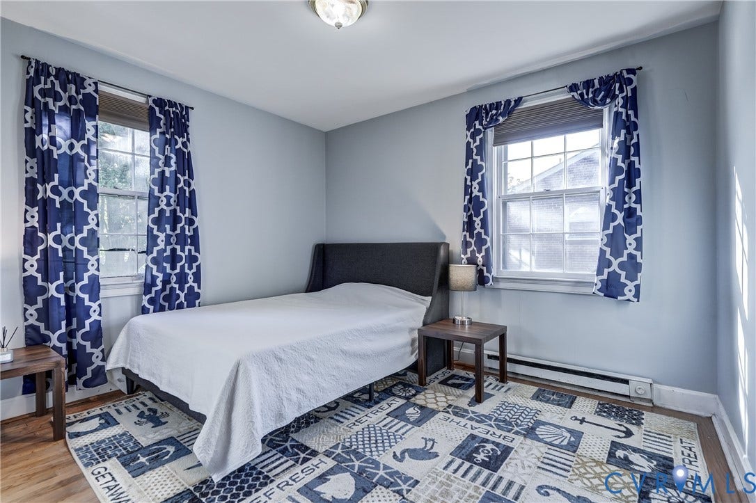 4007 Austin Avenue, Richmond, VA 23222 Room with wood-finish flooring, two windows with double-hung glass panes, and a flush-mount ceiling light fixture