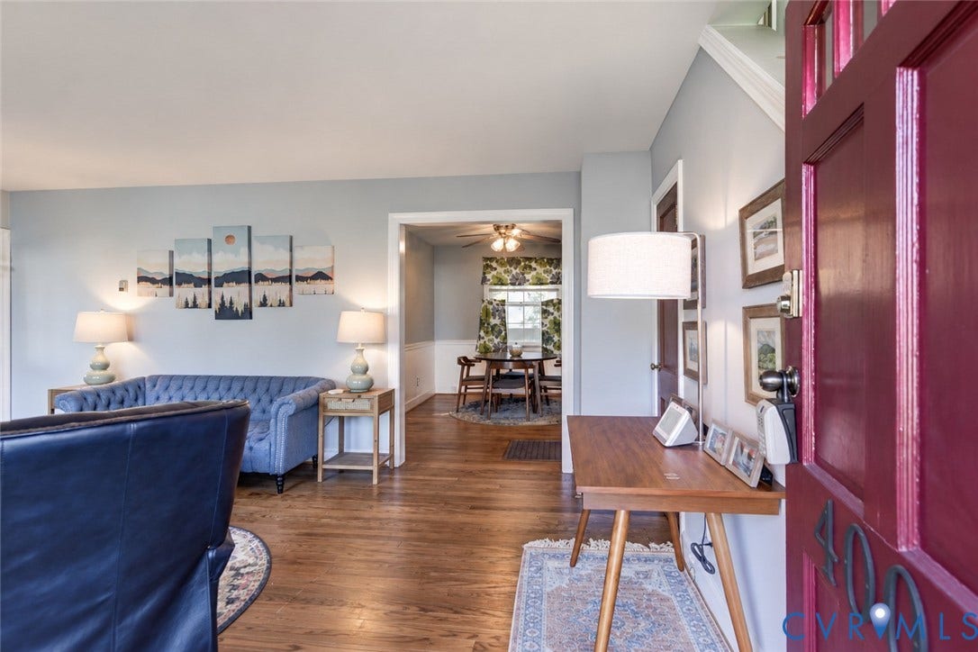 4007 Austin Avenue, Richmond, VA 23222 Entryway featuring a solid wood door with glass pane inserts, hardwood flooring, and chair rail molding