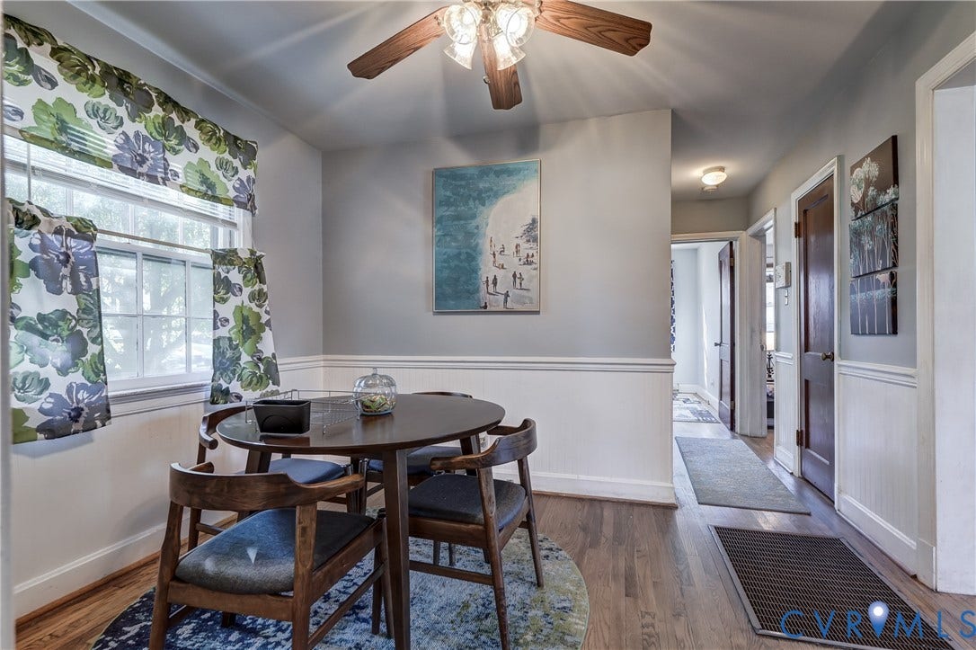 4007 Austin Avenue, Richmond, VA 23222 Wood-finish flooring, white wainscoting, multi-pane windows, and a ceiling-mounted light fixture with a fan