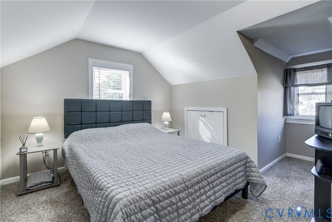 4007 Austin Avenue, Richmond, VA 23222 Vaulted ceilings with dormer window, neutral wall palette, and built-in knee-wall storage access