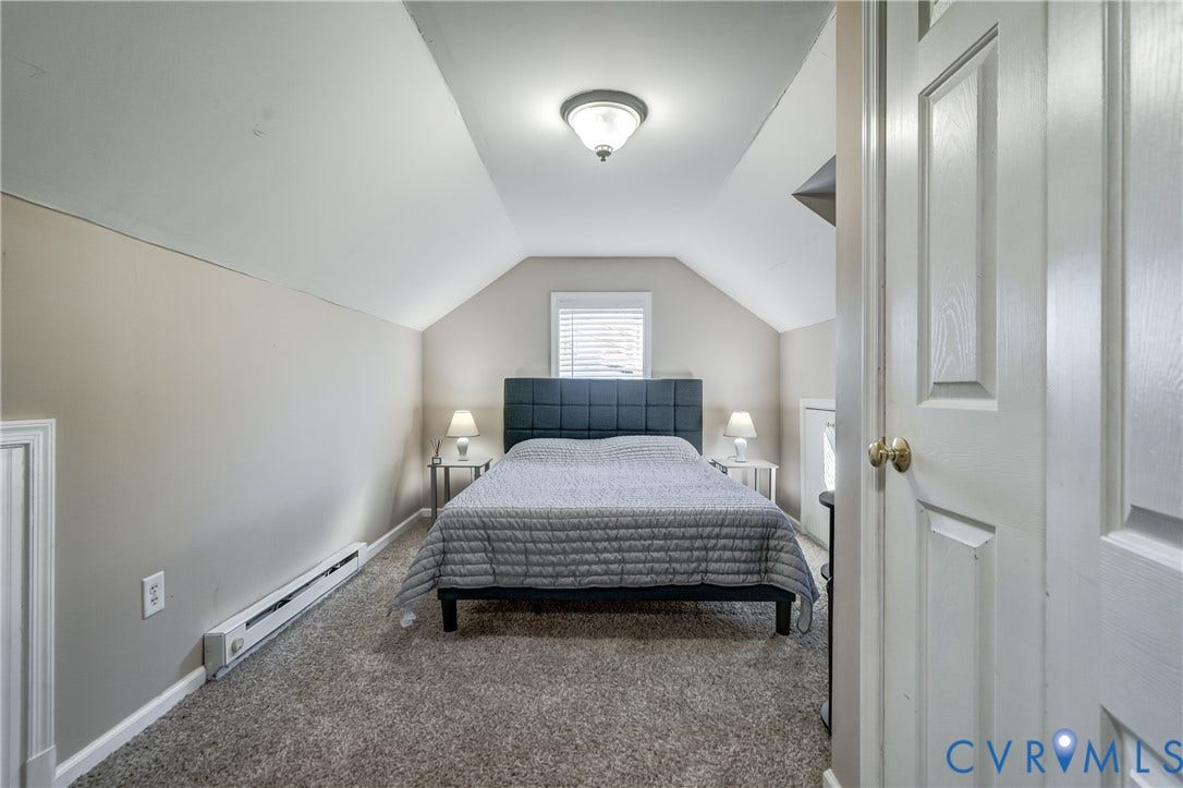 4007 Austin Avenue, Richmond, VA 23222 Room featuring carpeted flooring, vaulted ceilings, and a central window with sloped architectural walls