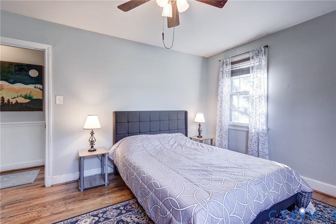 4007 Austin Avenue, Richmond, VA 23222 Wood-finish flooring, neutral wall tones, multi-light ceiling fan, and window featuring light-filtering treatments