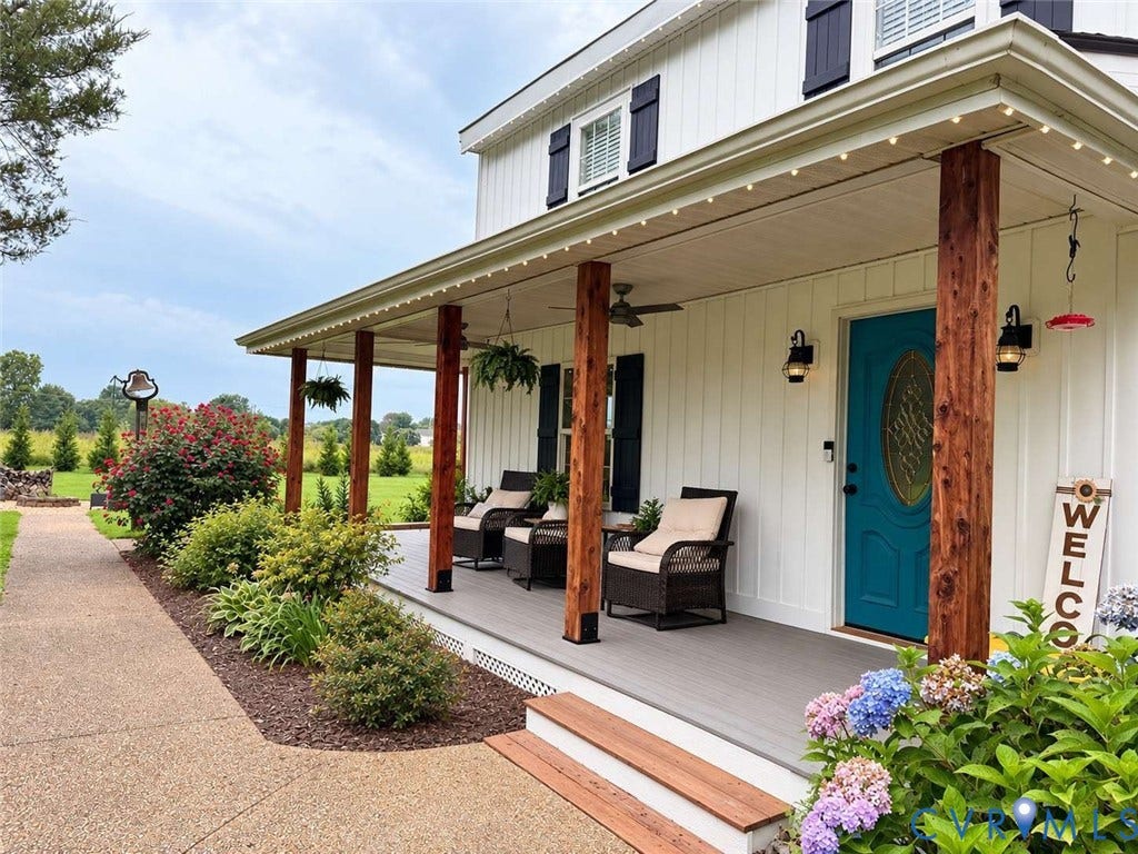 5424 Bellswood Drive, Mechanicsville, VA 23111 Board and batten siding, wraparound covered porch with wood-finish posts, and a decorative glass-inset entry door