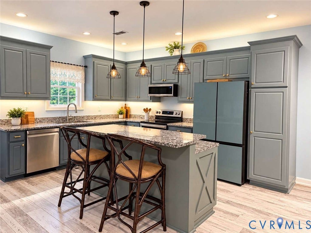 5424 Bellswood Drive, Mechanicsville, VA 23111 Kitchen featuring custom blue-gray cabinetry, stone-surface countertops, central island, stainless steel appliances, and hanging cage-style pendant lighting