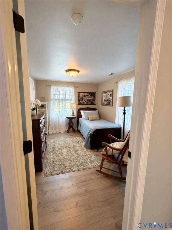 5424 Bellswood Drive, Mechanicsville, VA 23111 Room featuring light wood-finish flooring, two large windows, and dual ceiling-mounted lighting fixtures