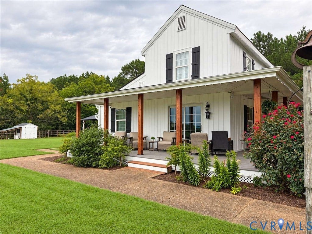 5424 Bellswood Drive, Mechanicsville, VA 23111 Vertical siding exterior featuring a wraparound porch with stained wood posts, decorative shutters, and expansive lawn space