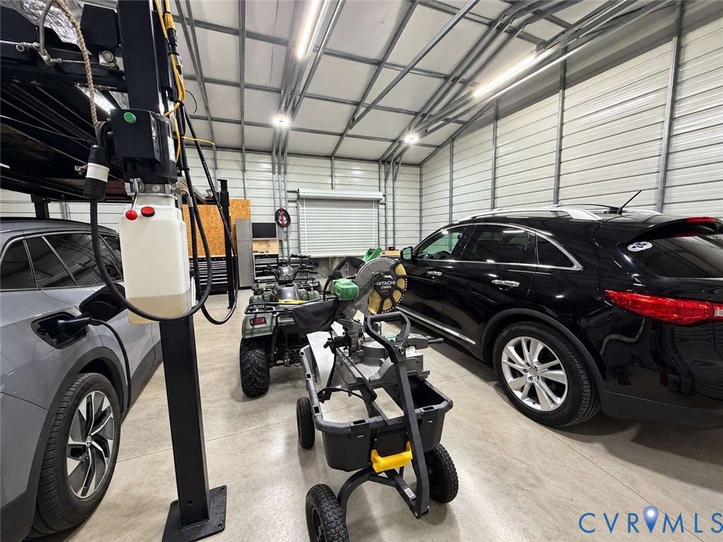5424 Bellswood Drive, Mechanicsville, VA 23111 Detached workshop featuring corrugated metal walls, concrete flooring, high-clearance overhead door, and LED tube lighting