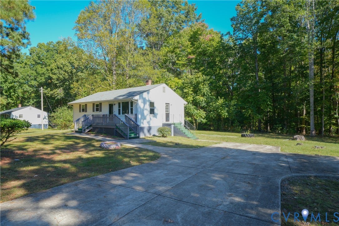 3622 New Bethel Road, Meherrin, VA 23954 Exterior featuring white siding, a concrete driveway, raised wood-finish decking, and mature trees on a lot