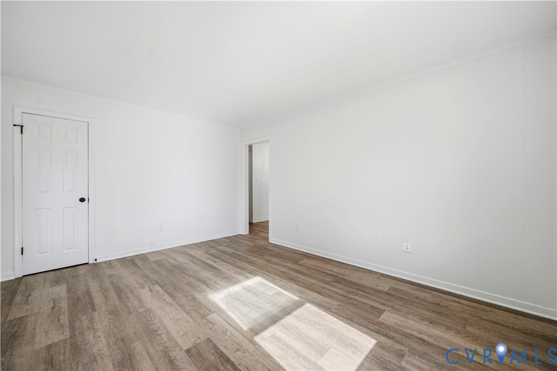 3622 New Bethel Road, Meherrin, VA 23954 Interior room featuring wood-finish flooring, white paneling, and a six-panel door