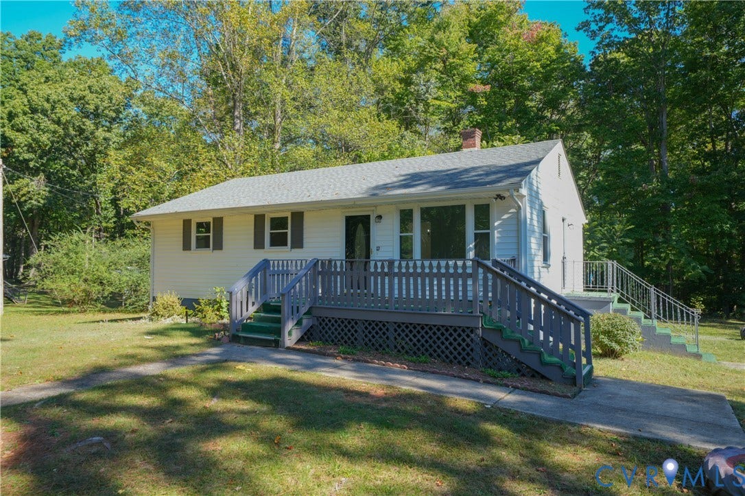 3622 New Bethel Road, Meherrin, VA 23954 Single-story exterior with light siding, gable roofline, elevated wood-finish deck featuring lattice skirting, and concrete walkway